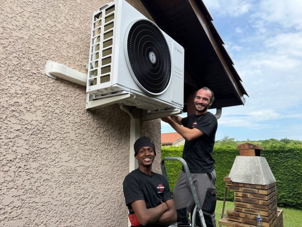 Techniciens VIP Services installant une climatisation Bosch sur le mur extérieur d'une maison.
